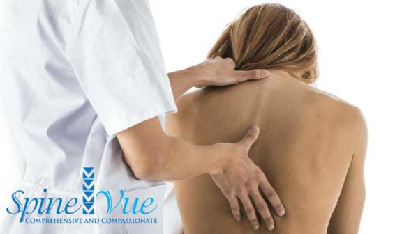 Doctor treating patient's back pain