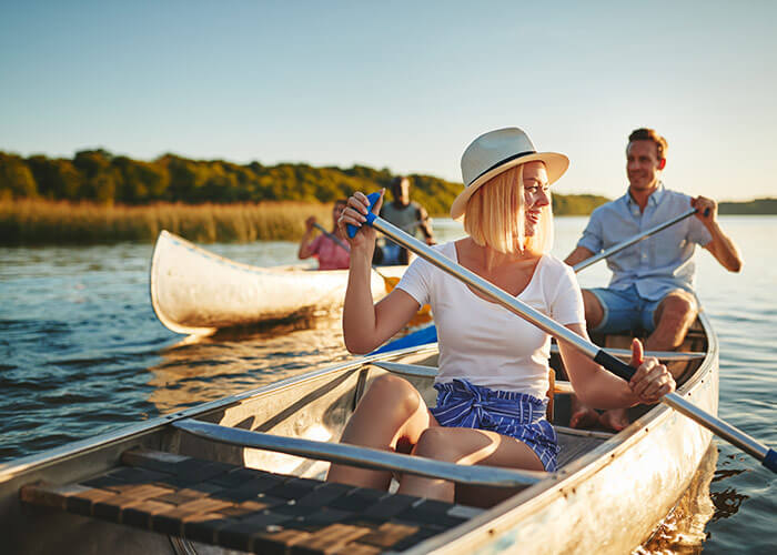 happy couple canoeing down river