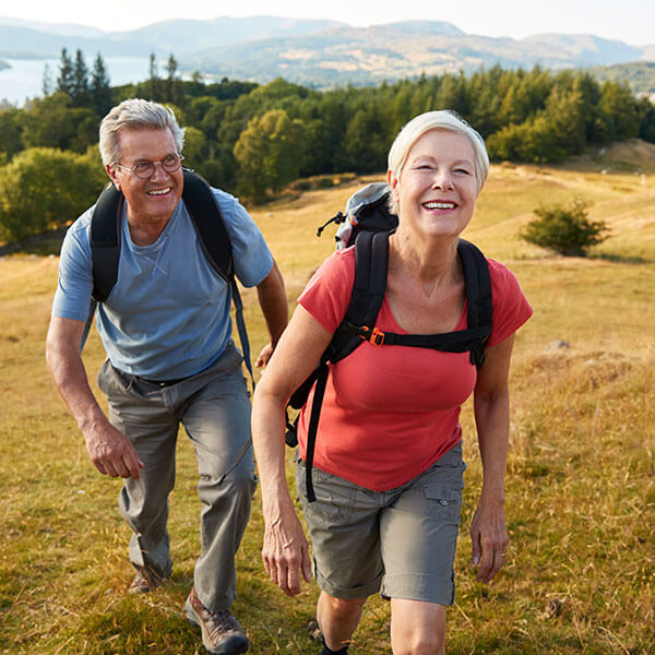 elderly couple walking on hike
