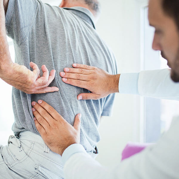 doctor with hands on patients back