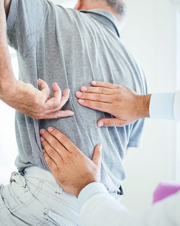 doctor with hands on patients back