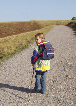 Kid carrying her school bag