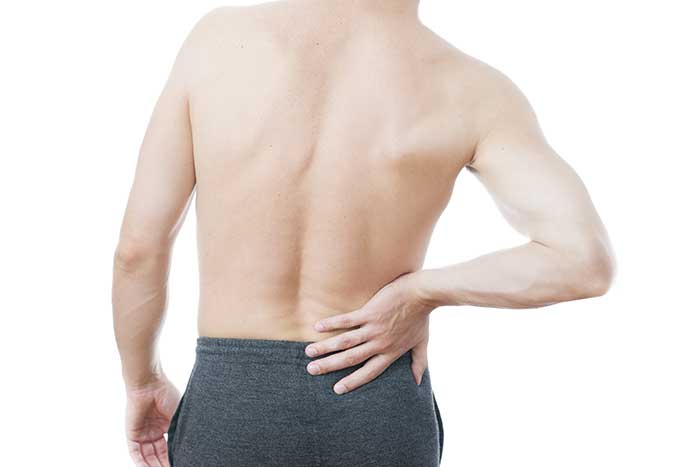 A man touching his back pain