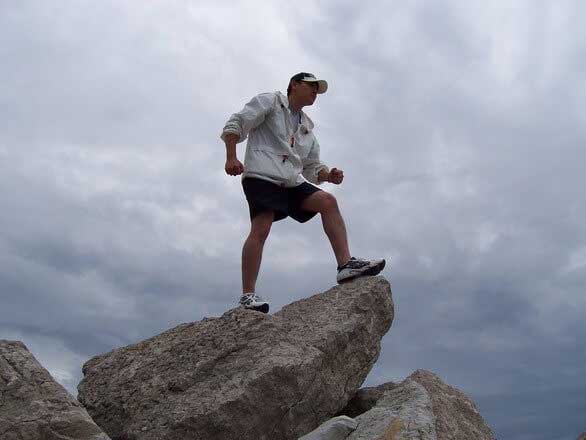 A boy standing on a height on stone