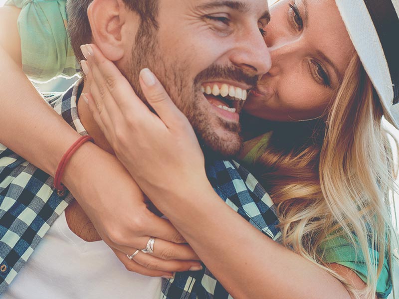 woman kissing man on cheek
